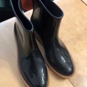 Melissa rain boots.  Glossy black with tan sole.  Size 9